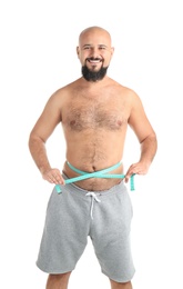 Photo of Overweight man with measuring tape on white background