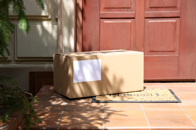 Photo of Delivered parcel on door mat near entrance