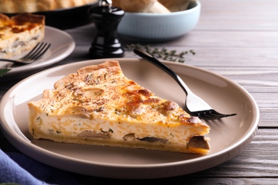 Photo of Delicious pie with mushrooms and cheese served on wooden table, closeup