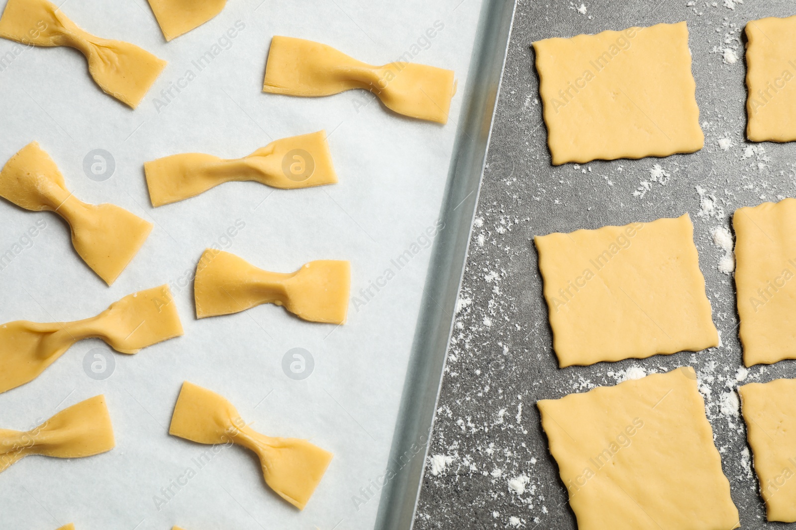 Photo of Homemade farfalle pasta on grey table, flat lay