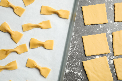 Photo of Homemade farfalle pasta on grey table, flat lay