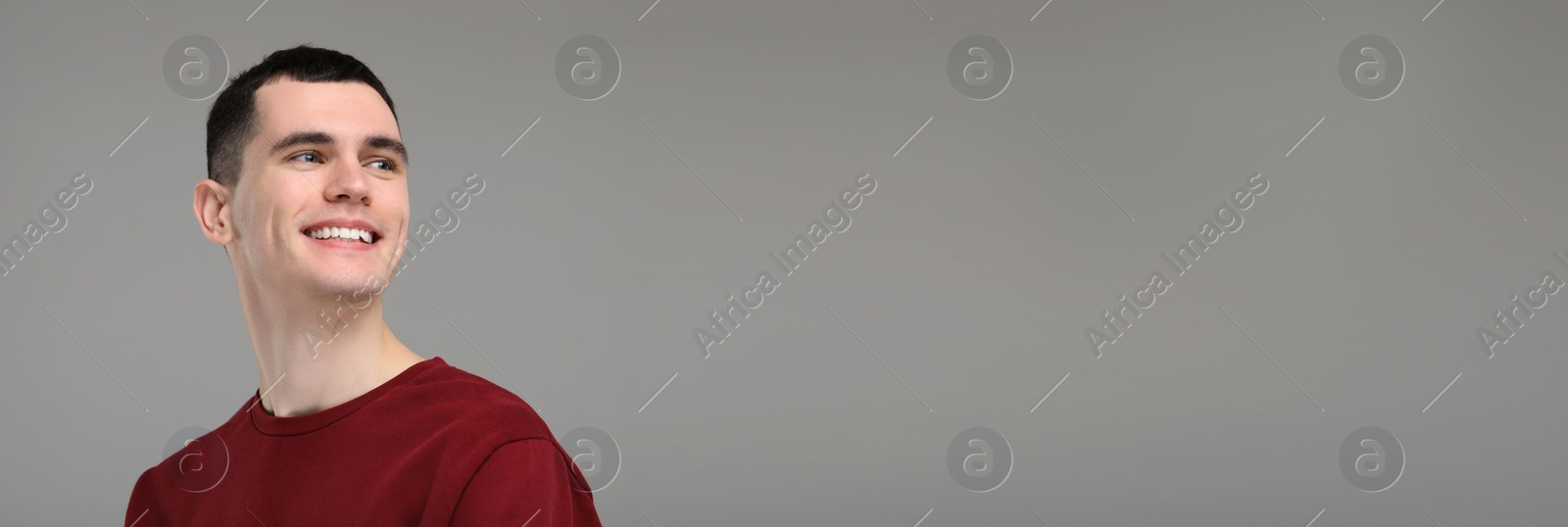 Image of Man with clean teeth smiling on grey background, space for text. Banner design