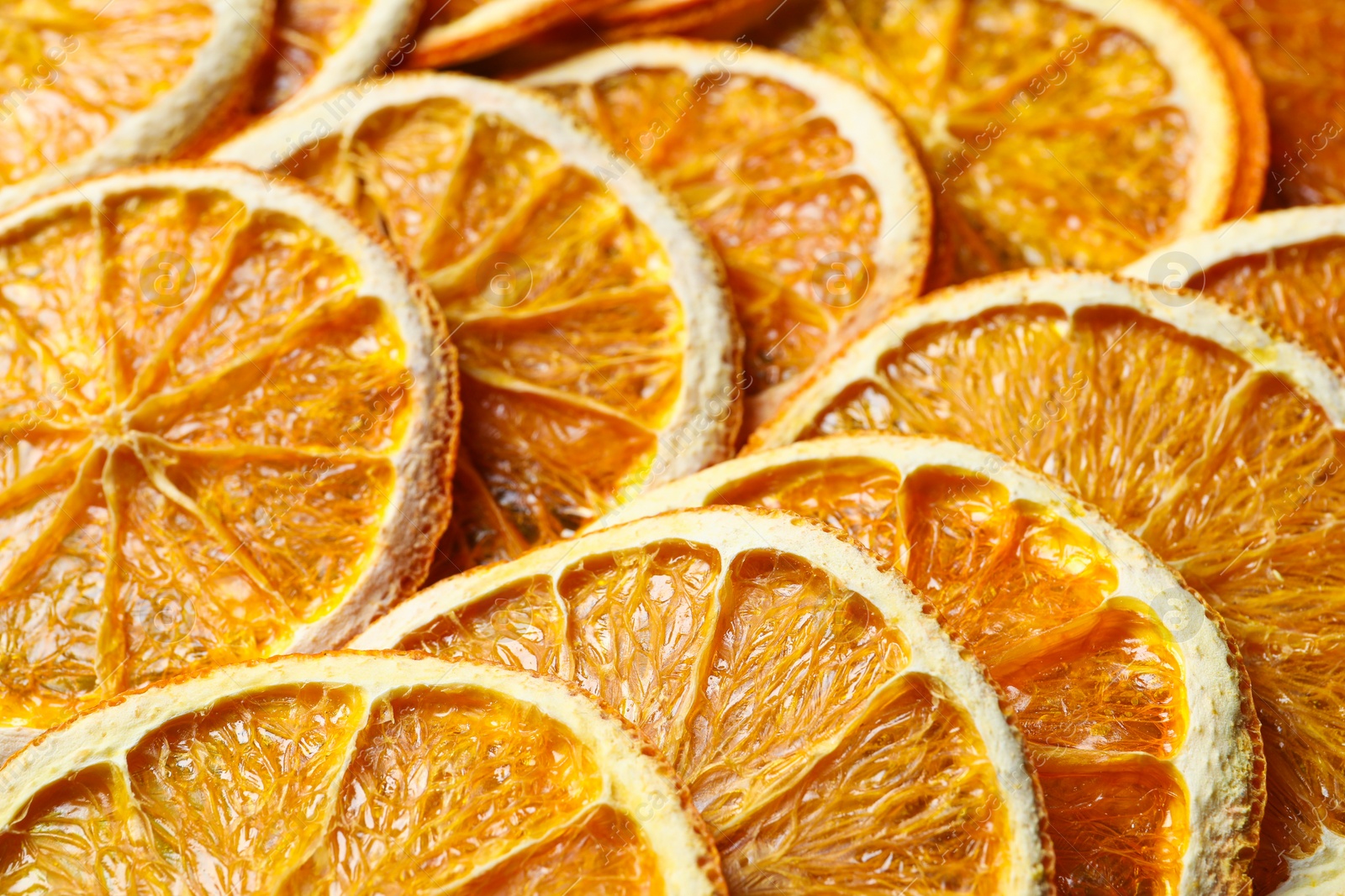 Photo of Heap of dry orange slices as background, closeup view