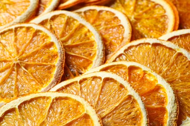 Photo of Heap of dry orange slices as background, closeup view