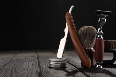 Photo of Moustache and beard styling tools on wooden table. Space for text