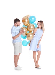 Young couple with air balloons on white background