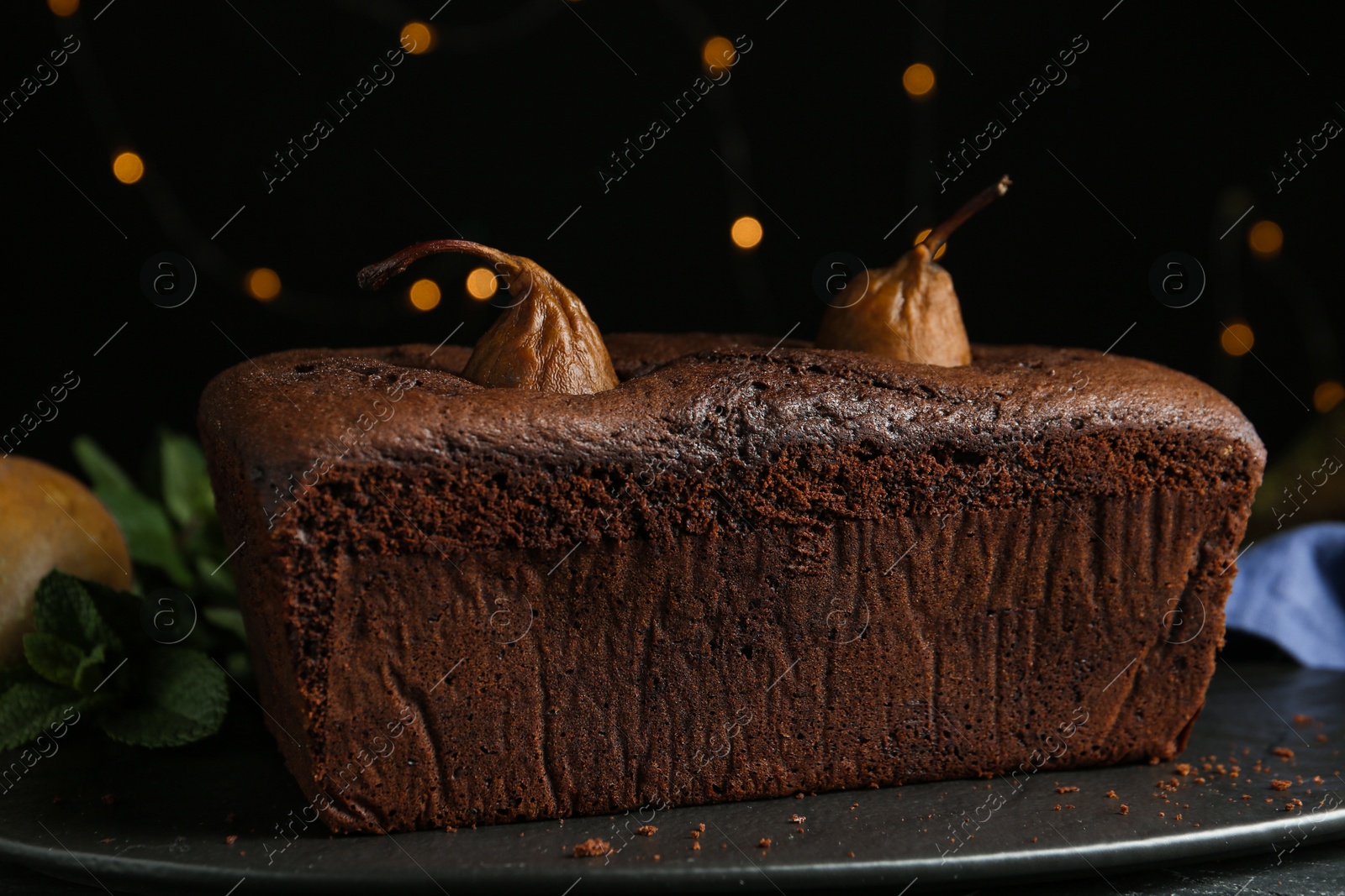 Photo of Tasty pear bread on slate board. Homemade cake