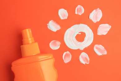 Drawing of sun and bottle with sunscreen on coral background, top view. Skin protection