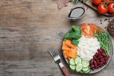 Photo of Tasty rice with beans served on wooden table, flat lay. Space for text