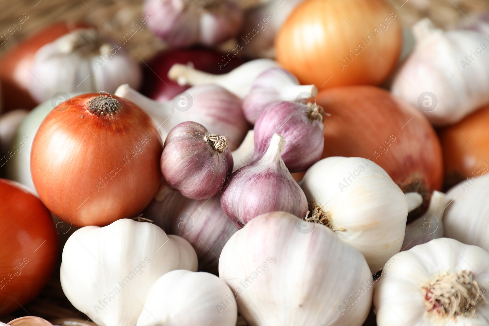 Photo of Fresh raw garlic and onions as background, closeup