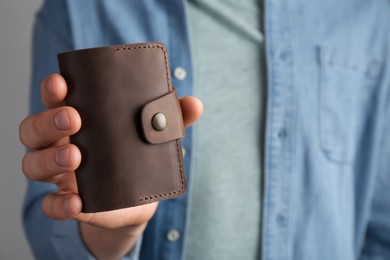 Man holding leather business card holder, closeup