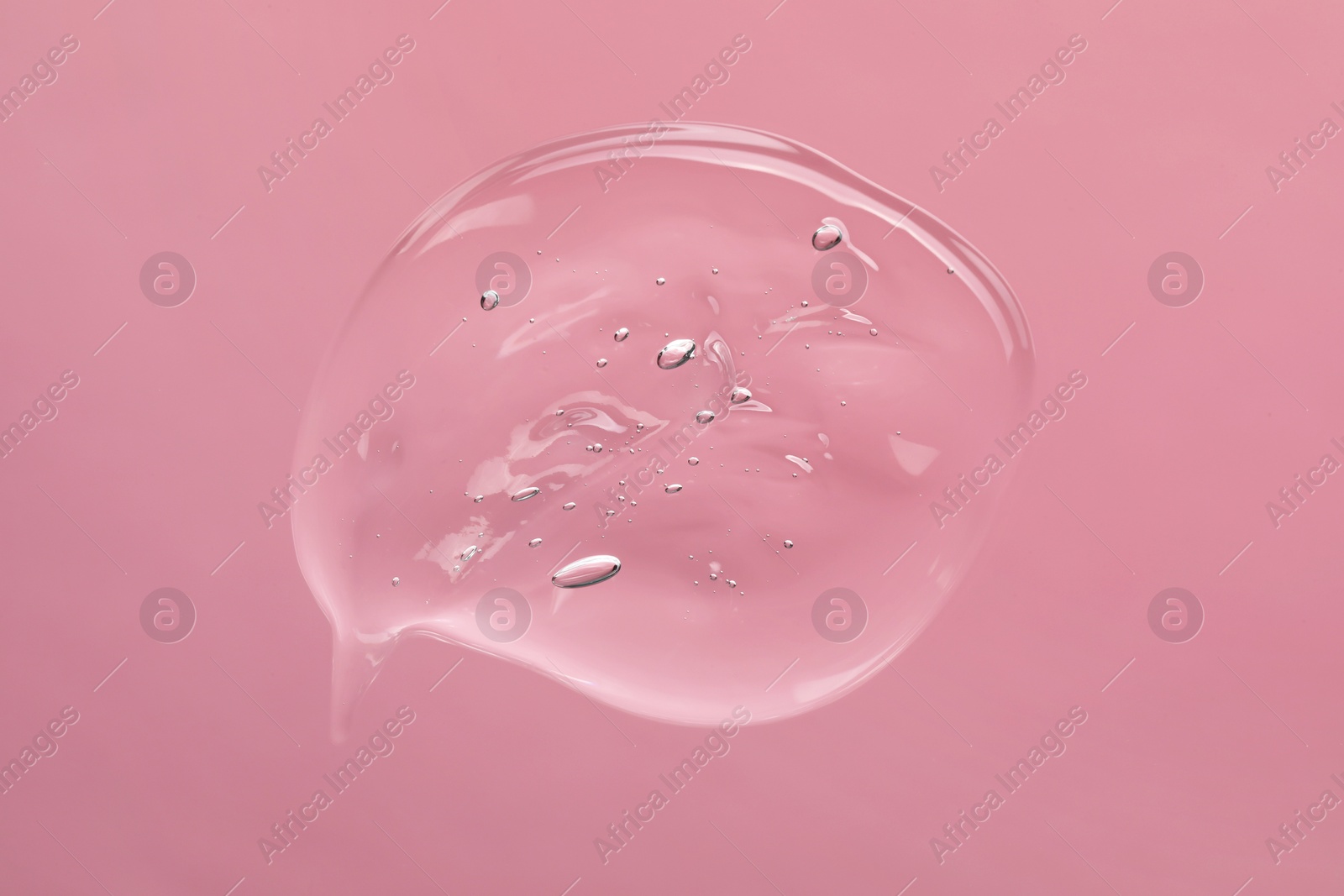 Photo of Sample of cleansing gel on light pink background, top view. Cosmetic product