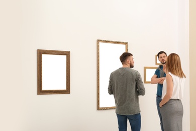 People viewing exposition in modern art gallery