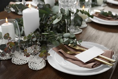 Luxury table setting with beautiful decor and blank card. Festive dinner