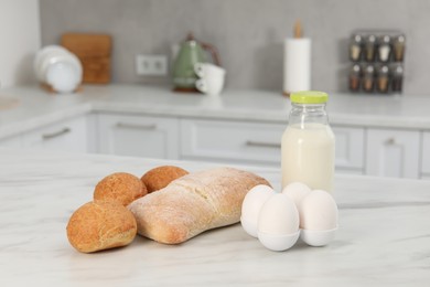 Photo of Allergenic food. Different fresh products on light marble table in kitchen