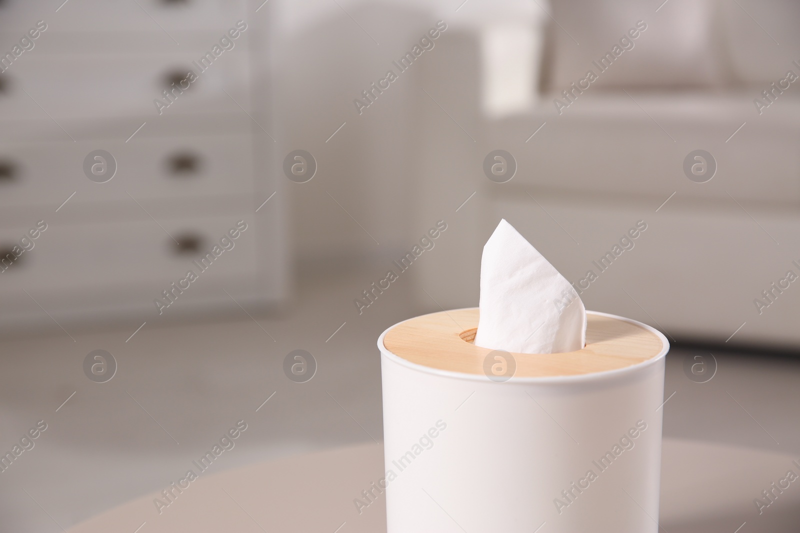 Photo of Box with paper tissues on light table in living room, closeup. Space for text