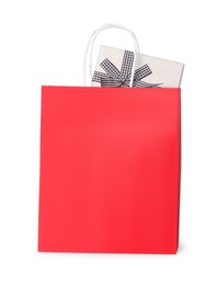 Red paper shopping bag with gift box on white background