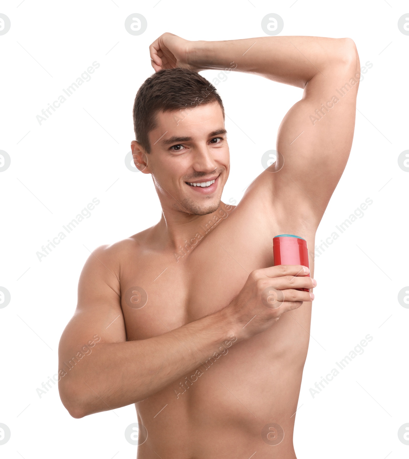 Photo of Young man applying deodorant to armpit on white background