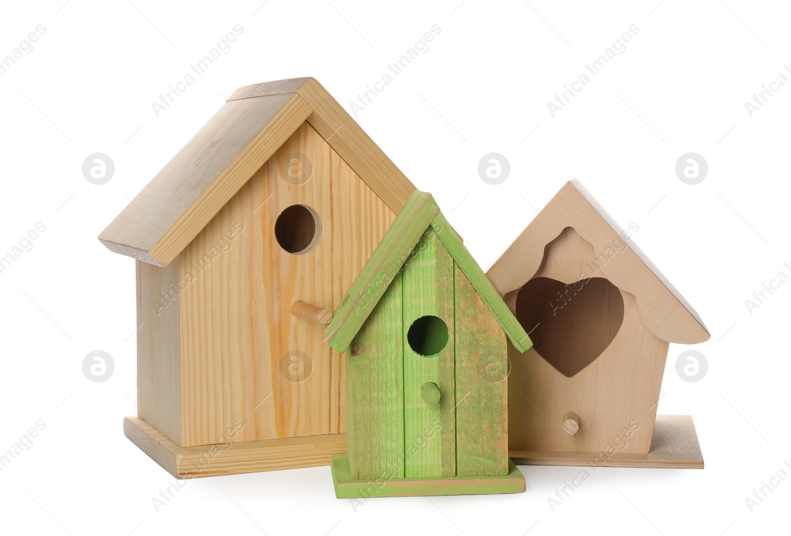 Photo of Three different bird houses on white background