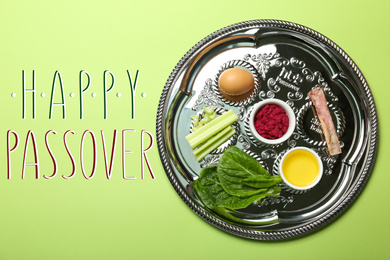 Image of Passover Seder plate (keara) with symbolic meal on green background, top view. Pesah celebration