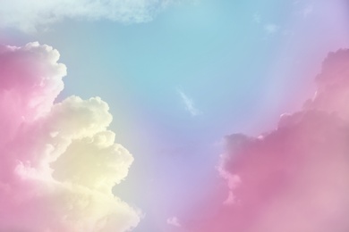 Image of Fantasy world. Picturesque view of beautiful magic sky with fluffy clouds, toned in pastel rainbow or unicorn colors