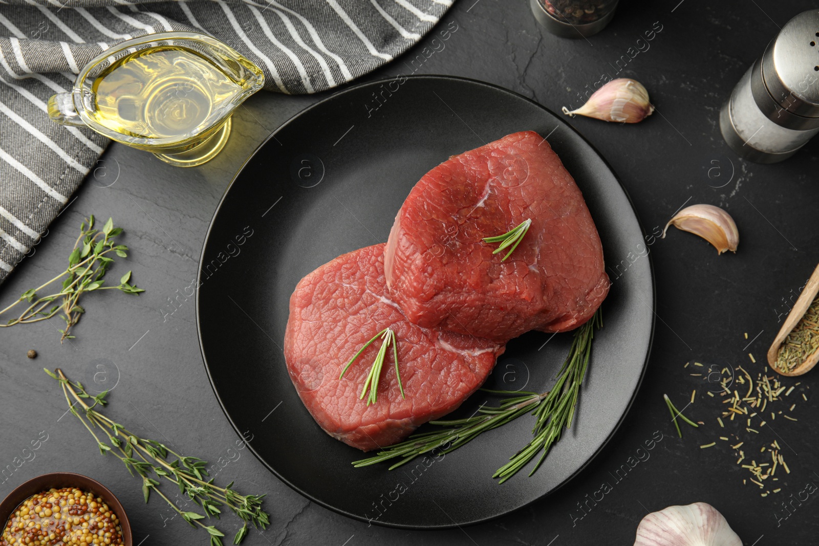 Photo of Flat lay composition with fresh beef cut on black table