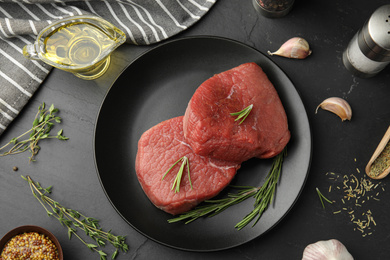 Photo of Flat lay composition with fresh beef cut on black table