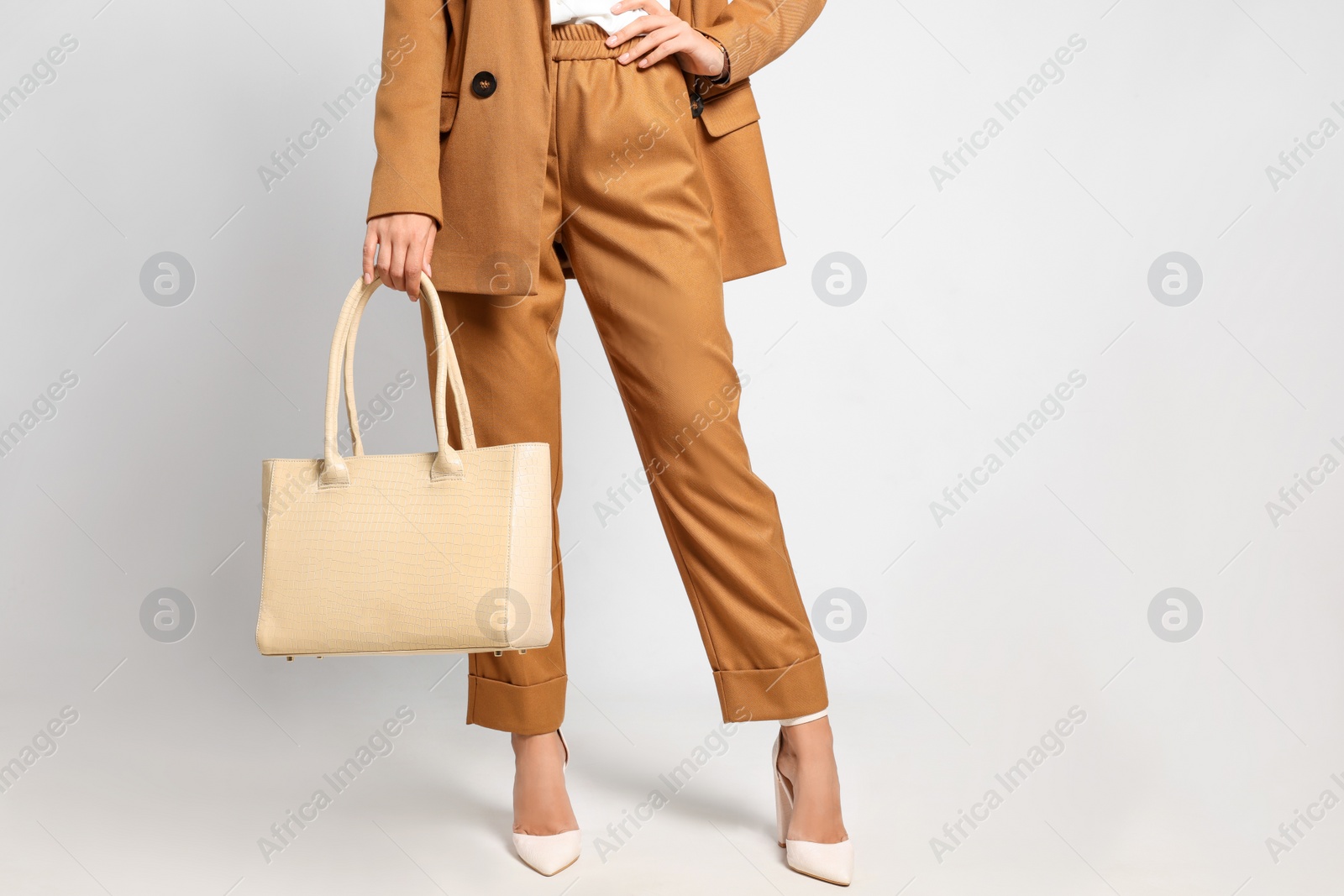 Photo of Young woman with stylish bag on white background, closeup