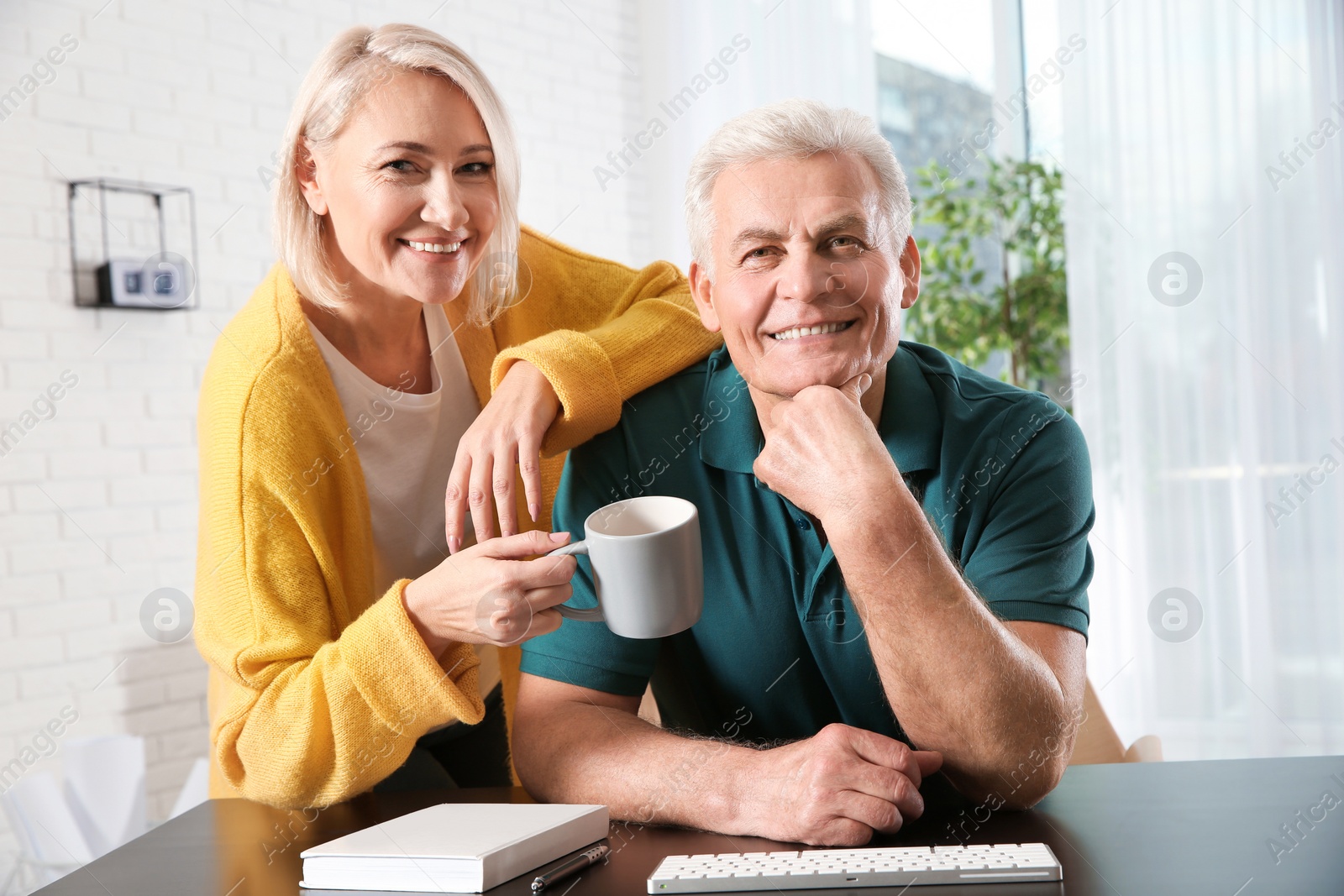 Photo of Mature couple using video chat at home, view from web camera