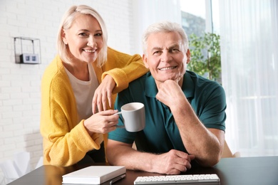 Mature couple using video chat at home, view from web camera