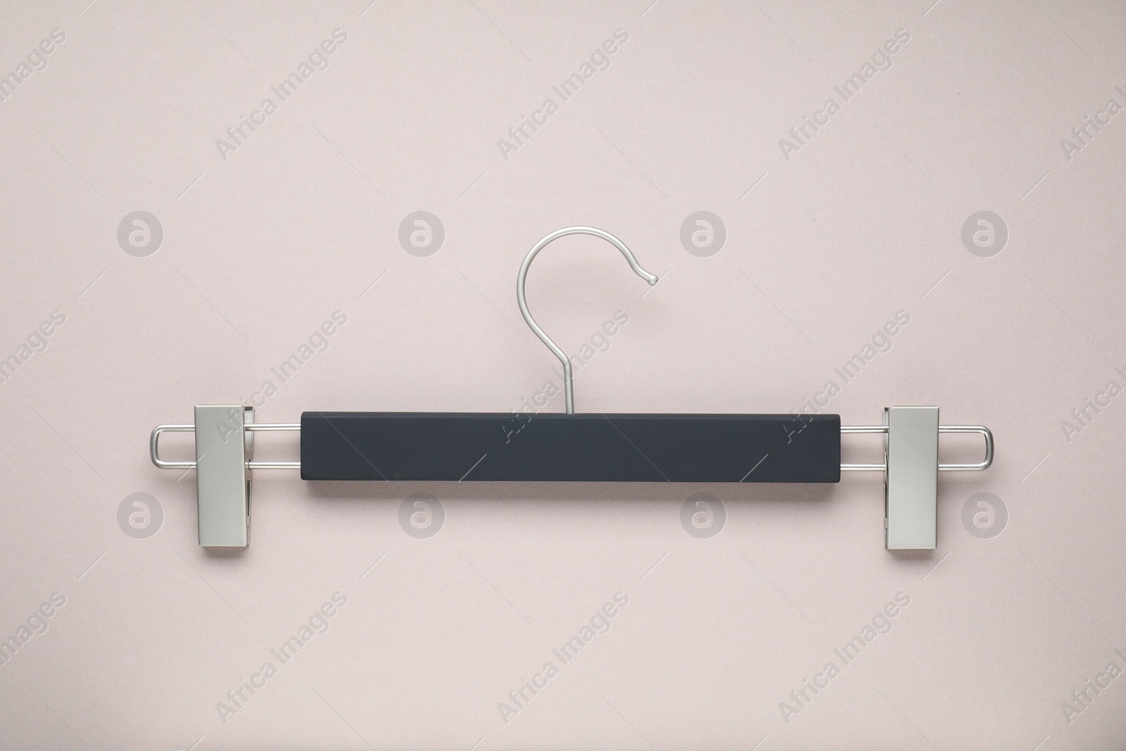 Photo of Empty hanger with clips on light grey background, top view