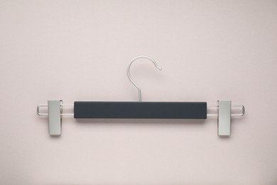 Empty hanger with clips on light grey background, top view