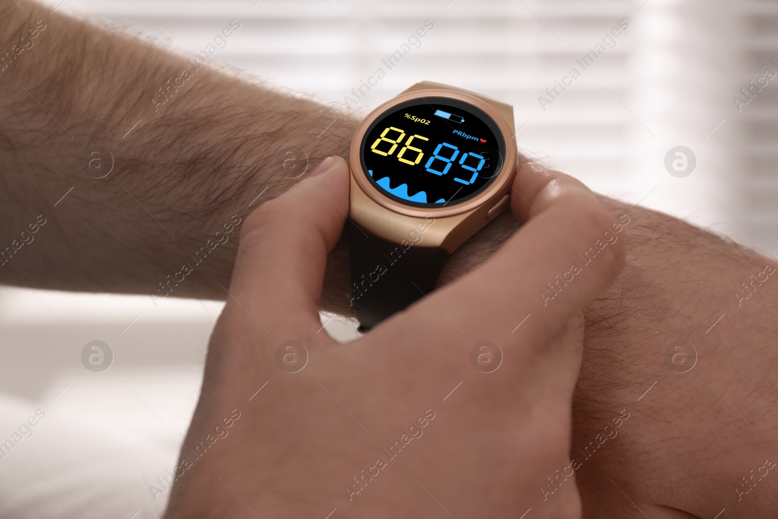 Image of Man measuring oxygen level with smartwatch indoors, closeup