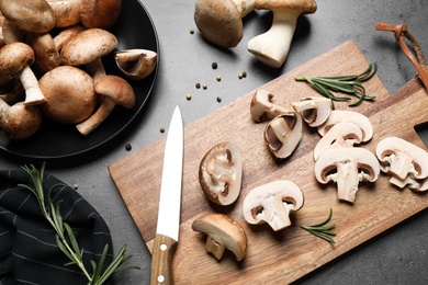 Flat lay composition with fresh wild mushrooms on grey table