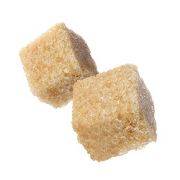 Flying cubes of brown sugar on white background