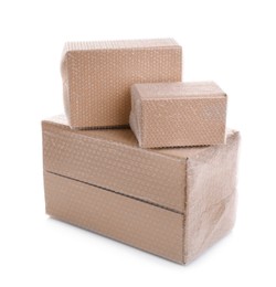 Photo of Cardboard boxes packed in bubble wrap on white background