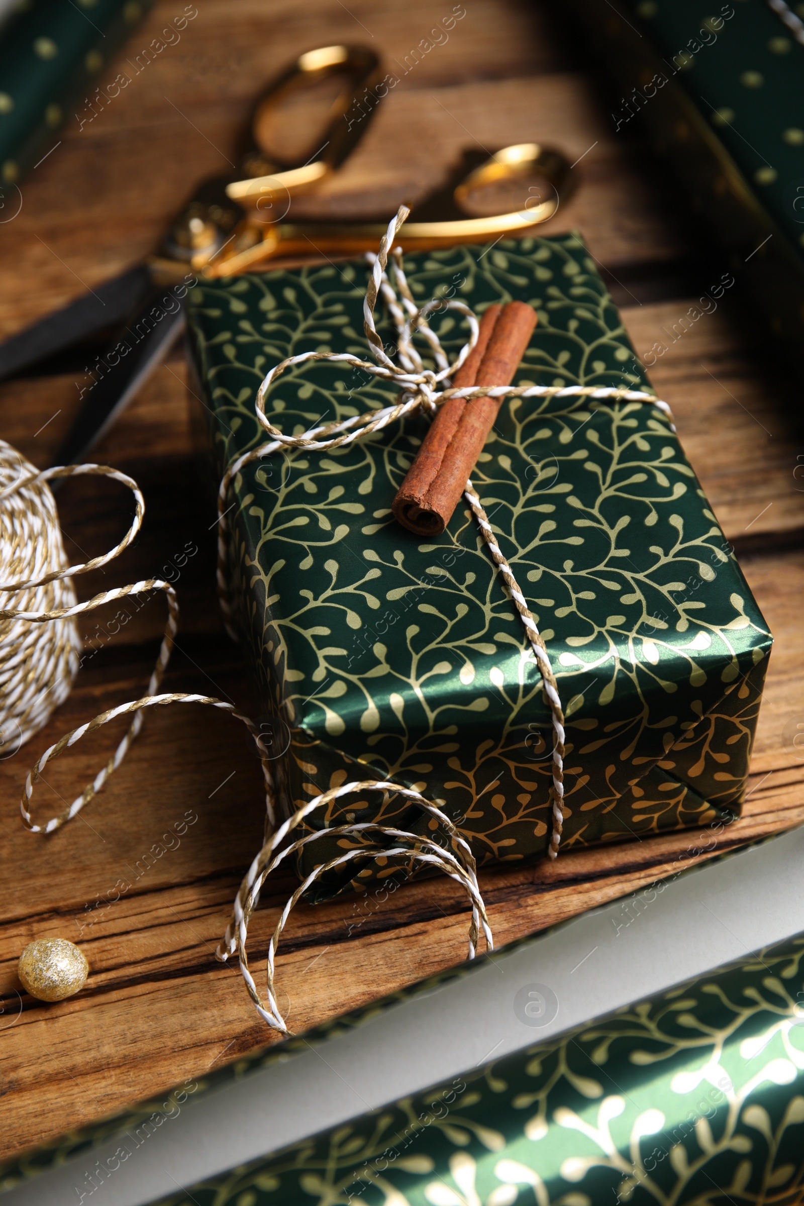 Photo of Composition with beautifully wrapped gift box on wooden table