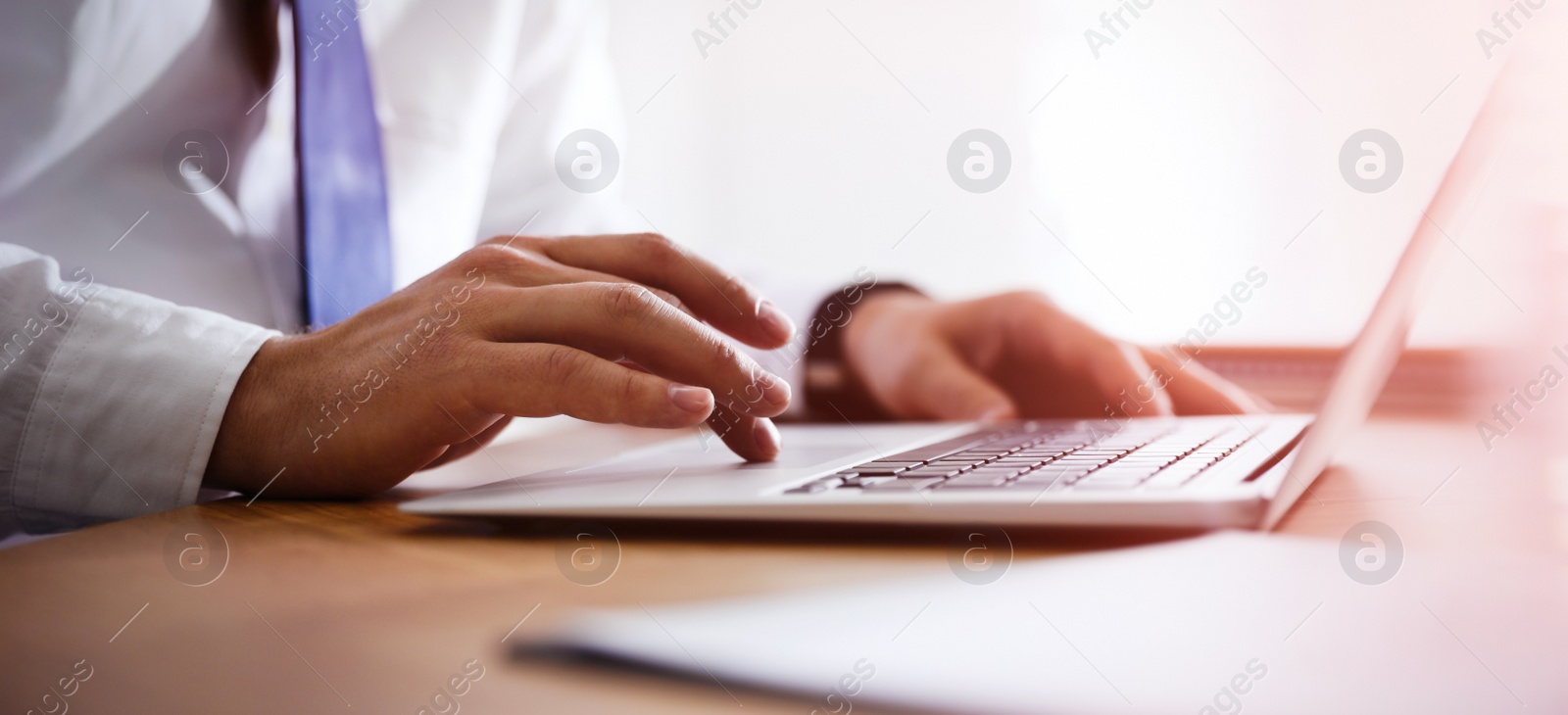 Image of Man working on computer at table in office, closeup. Banner design