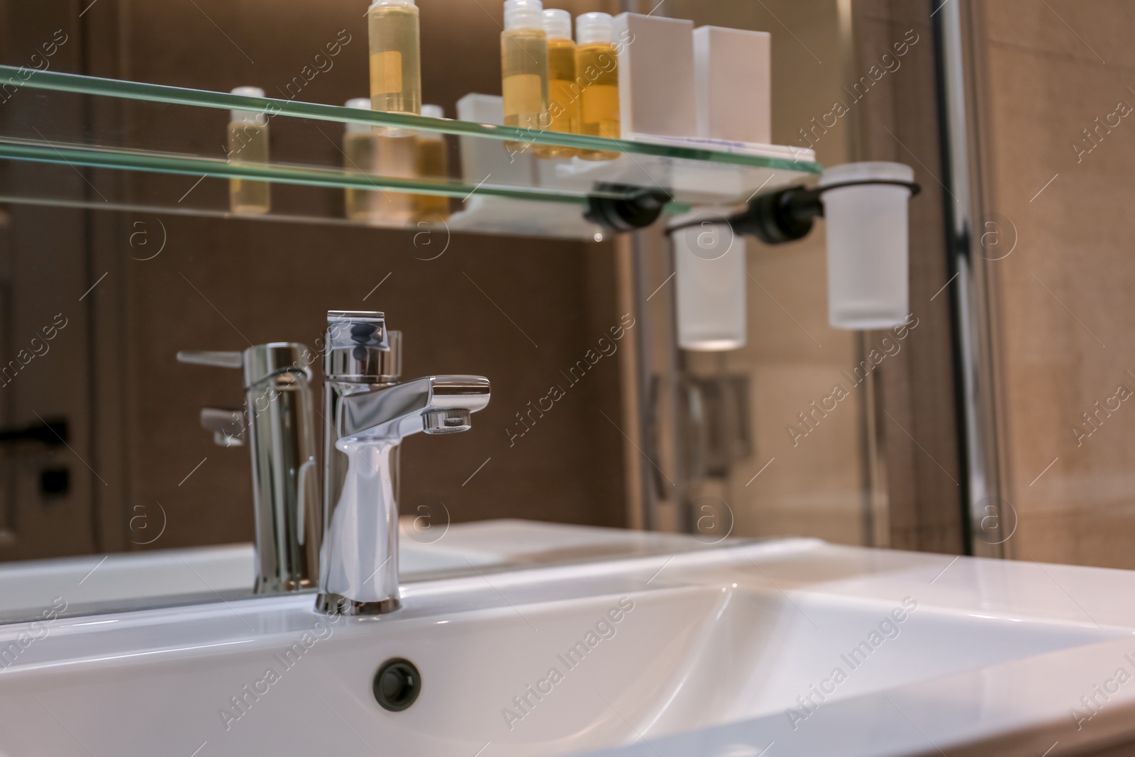 Photo of Chrome tap and white sink in bathroom