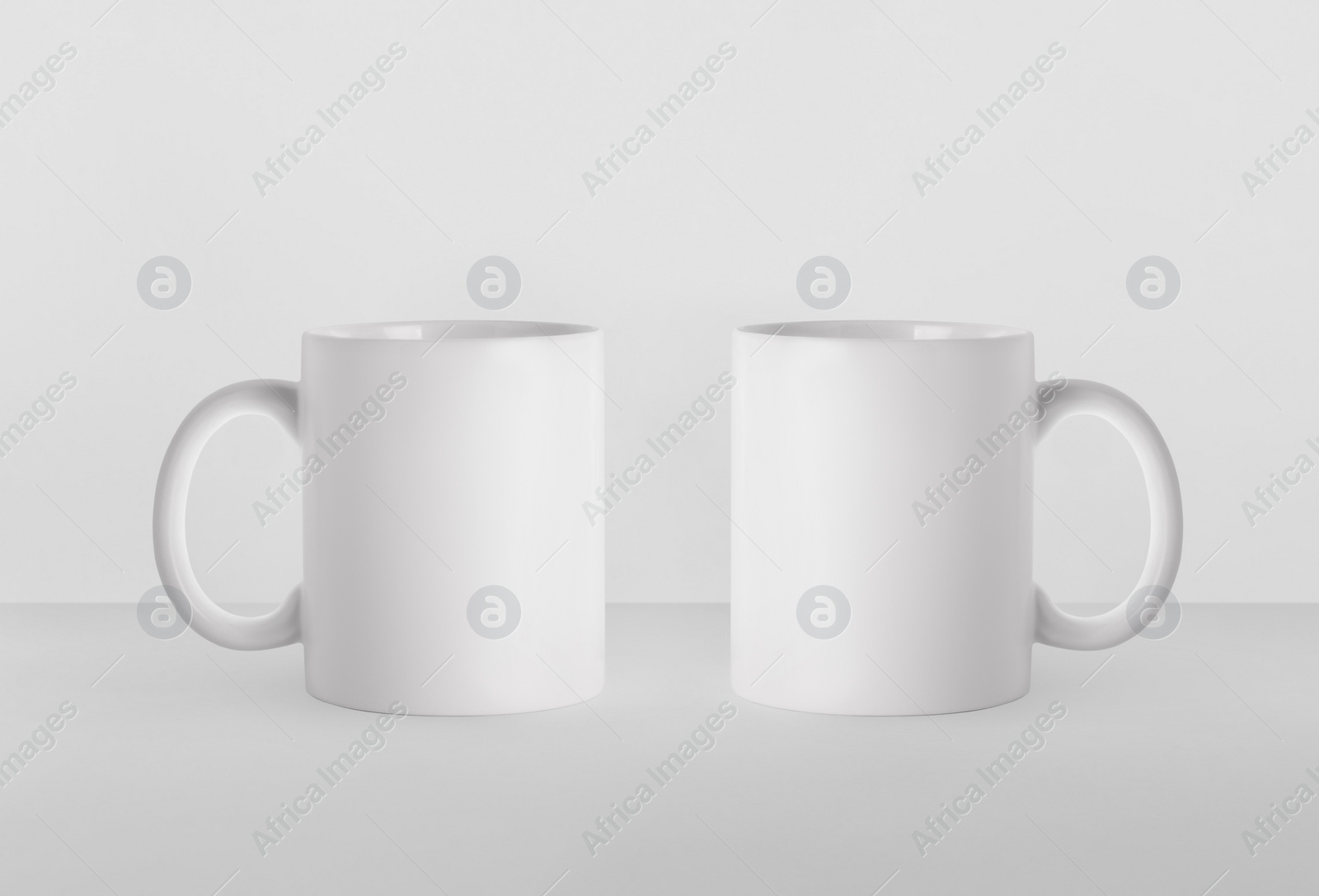 Image of Blank ceramic mugs on white background. Mockup for design