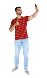 Photo of Happy young man taking selfie on white background