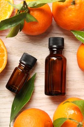 Photo of Flat lay composition with tangerine essential oil on wooden table
