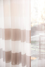 Window with elegant striped curtains in room
