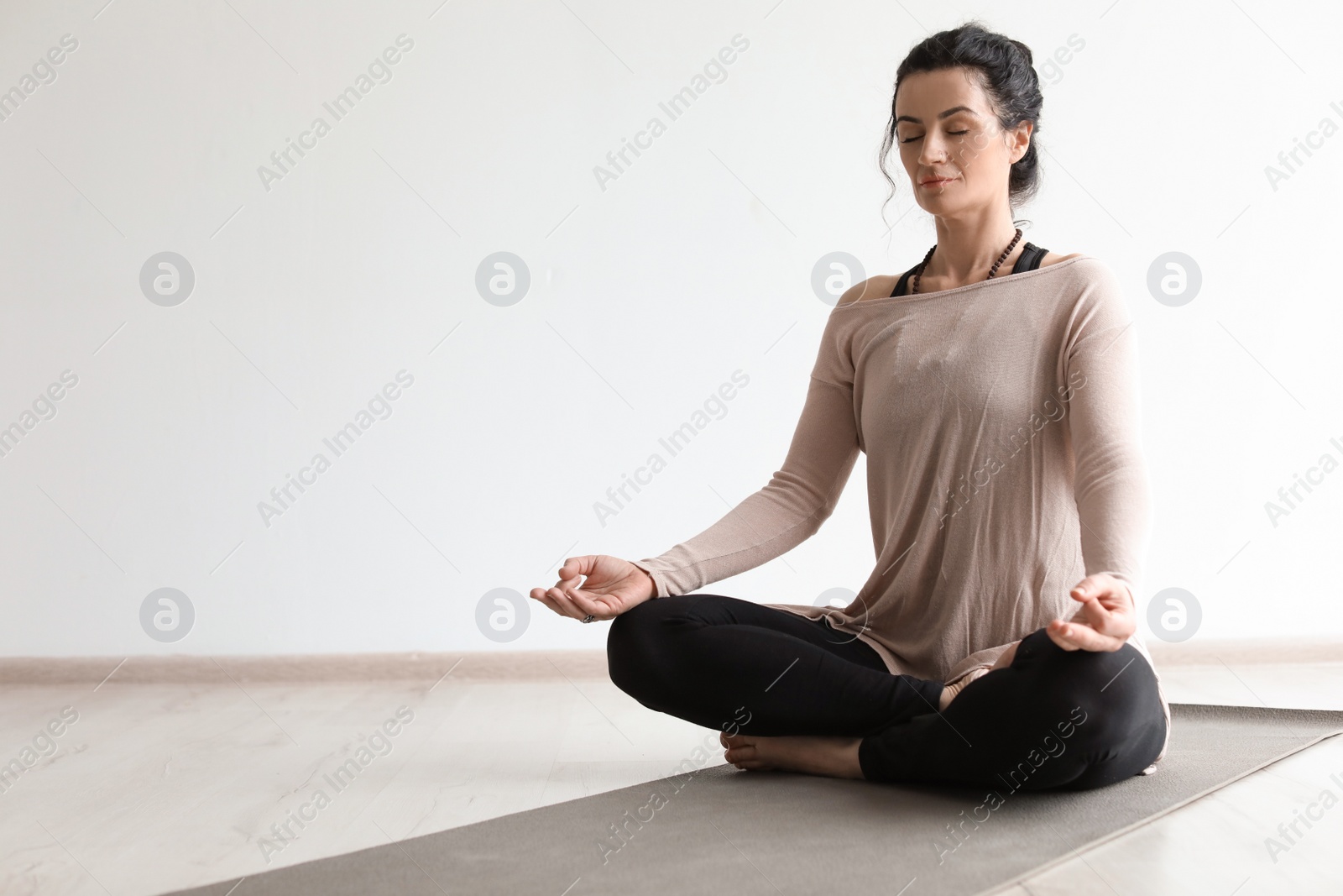 Photo of Sporty woman practicing yoga indoors