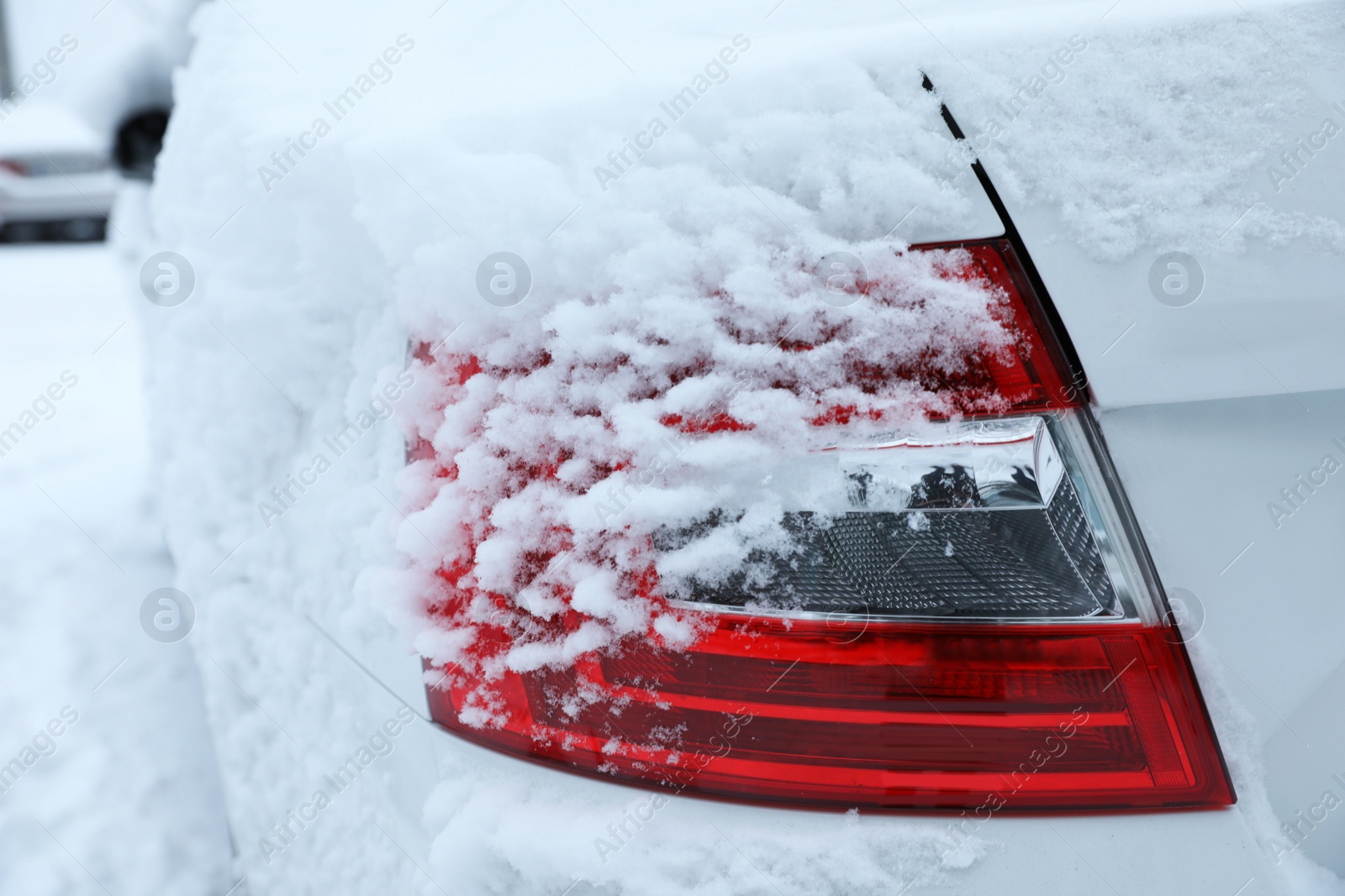 Photo of Modern car covered with snow outdoors on winter day, closeup. Frosty weather