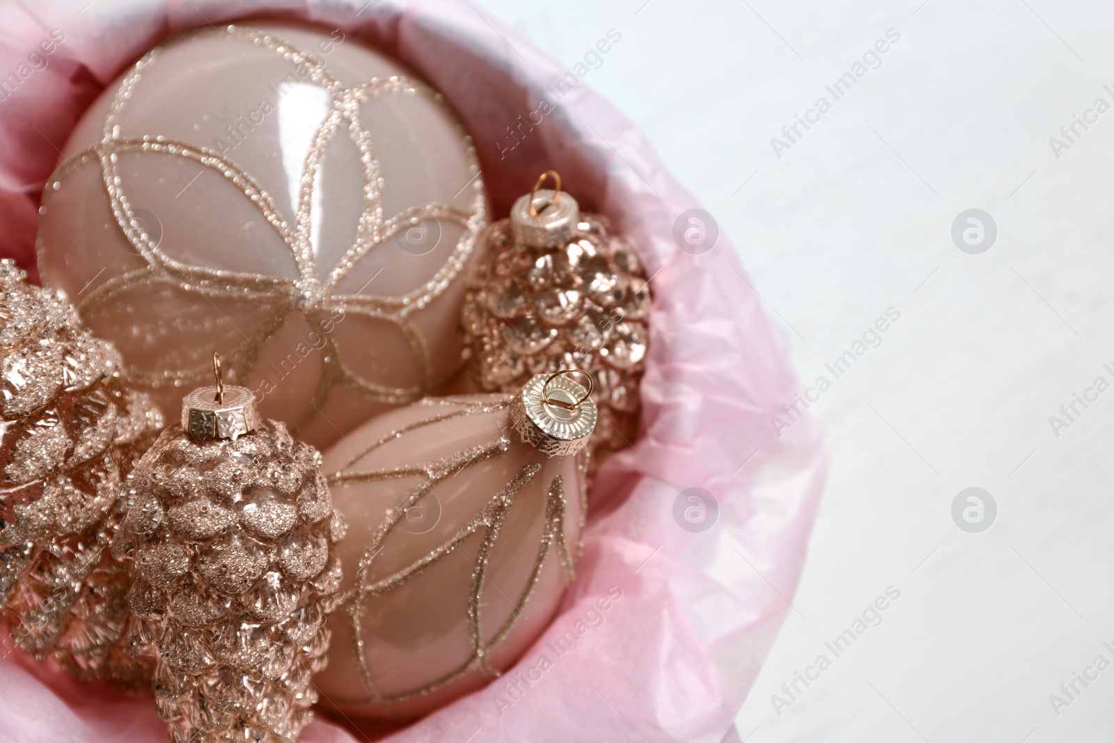 Photo of Collection of beautiful Christmas tree baubles on white table, closeup. Space for text