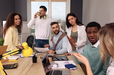 Photo of Team of employees working together in office. Startup project