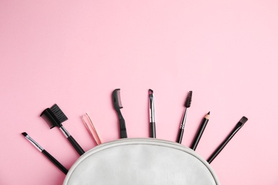 Set of professional eyebrow tools on pink background, flat lay. Space for text