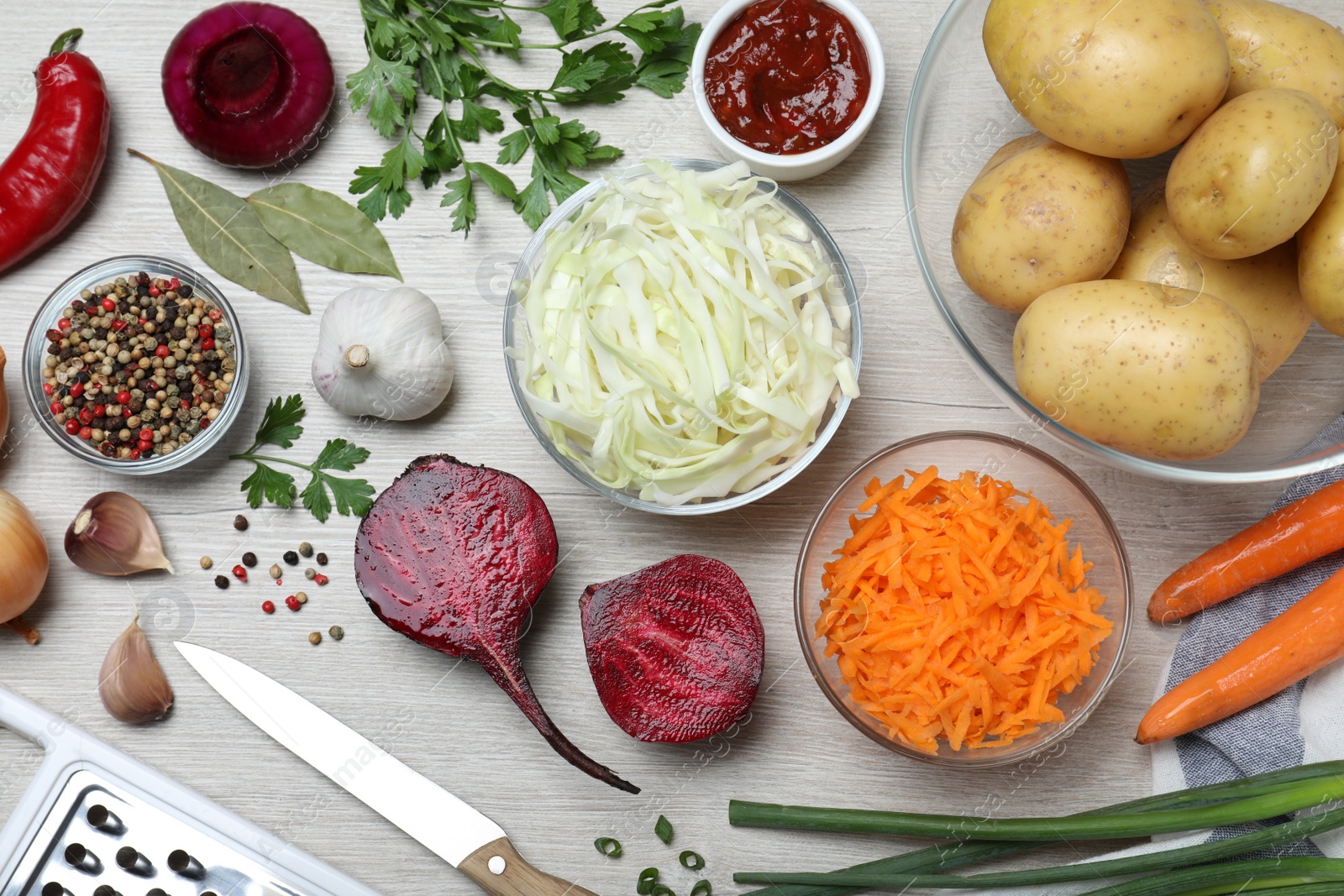 Photo of Fresh ingredients for borscht on white wooden table, flat lay