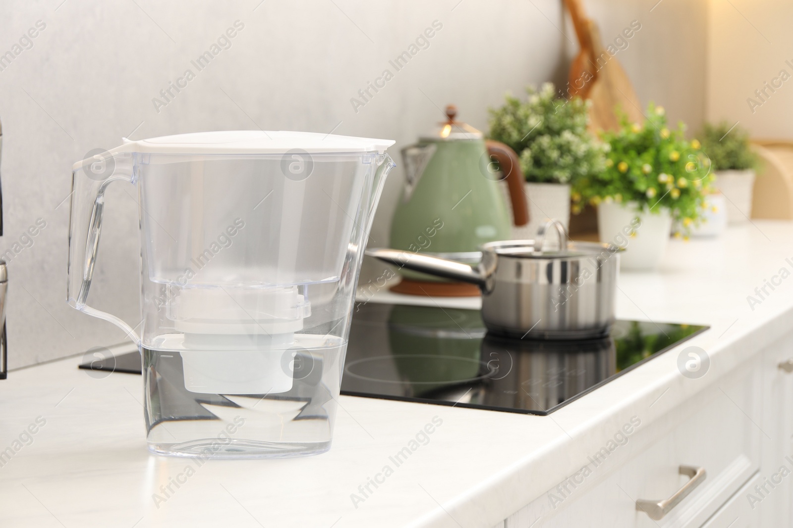 Photo of Water filter jug on white countertop in kitchen